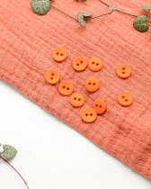 Bouton polyester mat 2 trous orange 12mm