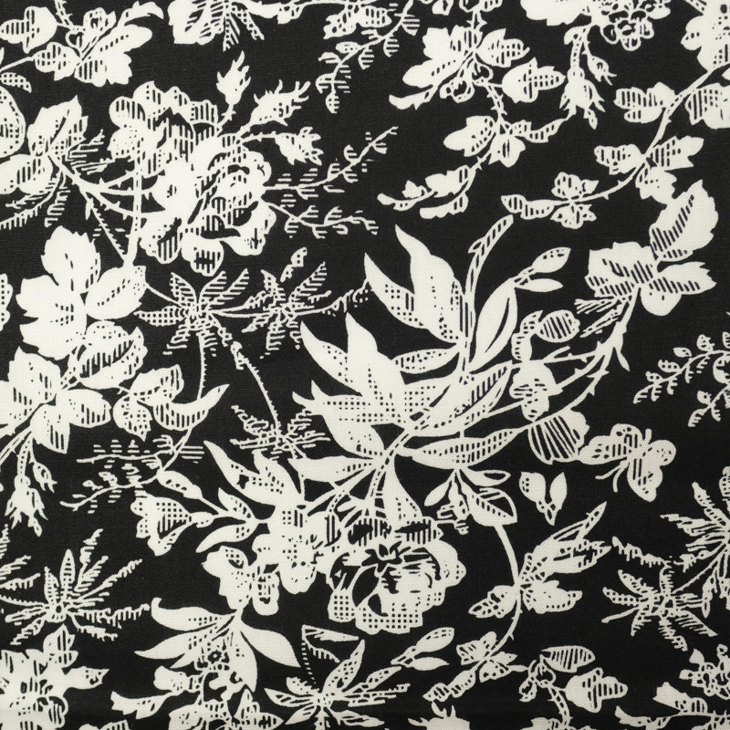 Tissu coton fleuri noir à motifs blancs à petit prix - Cuirtex